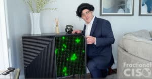 Auditor Rob standing in front of a home "server rack."